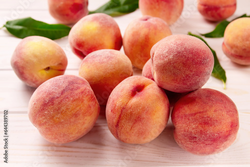 Fresh peaches on a wooden table.