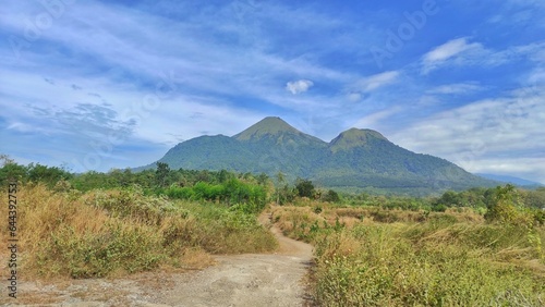 Natural outdoor view of 'Penanggungan' mountain from Indonesia with dirt road during sunny day photo
