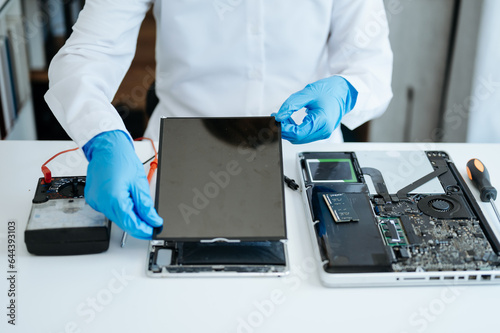 Electronics technician, electronic engineering electronic repair,electronics measuring and testing, repair and maintenance concepts.uses a voltage meter to check and upgrade