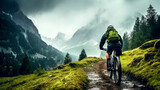 man riding a mountain bike on a mountain trail on a cloudy day