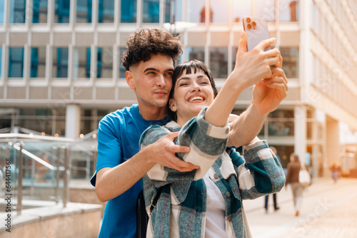 Smiling happy young couple taking selfie on smart phone Lifestyle concept