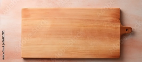 Wooden cutting board against a isolated pastel background Copy space