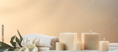 Light beige cubes with black bag white towels candles and Lily display for advertising hair removal wax isolated pastel background Copy space