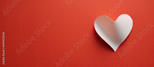 Red folded paper with heart cut out 3x6 cells on isolated pastel background Copy space photo