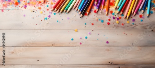 Selective focus on multi colored pencils and particle on a isolated pastel background Copy space