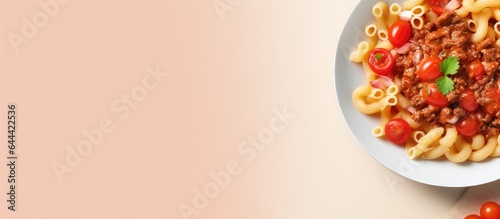 Pasta with pork goulash and tomato on a isolated pastel background Copy space