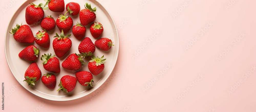 Strawberries arranged in a row on a black plate with space for text isolated pastel background Copy space Strawberries arranged in a row on a black plate with space for text isolated pastel background Copy space