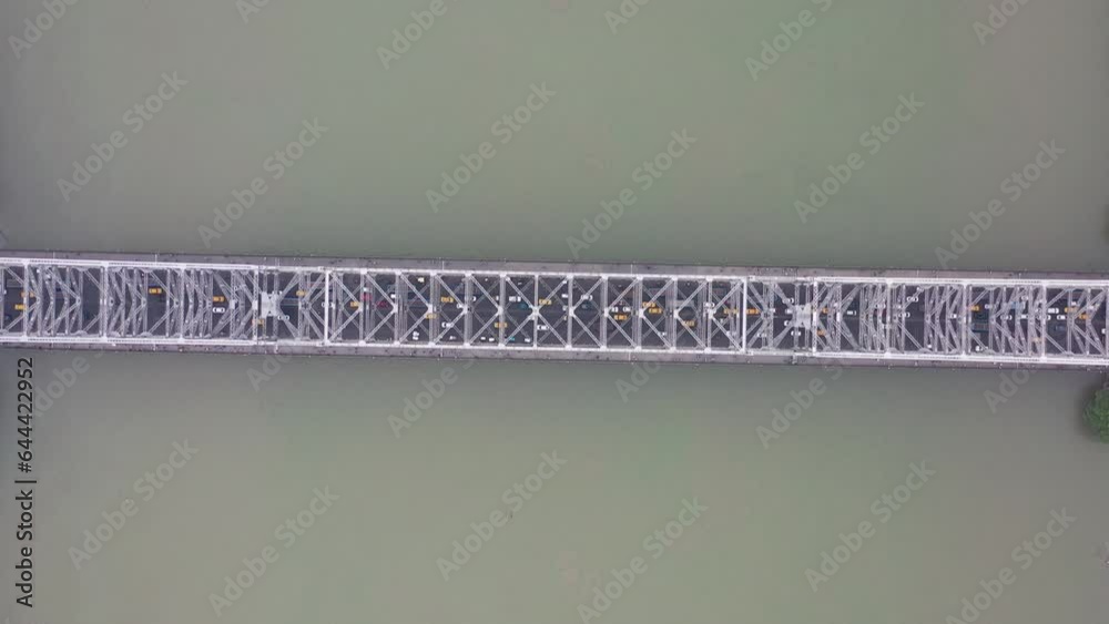 Aerial view of architectural landmark Howrah bridge or Rabindra Setu over the Hooghly River at night in Kolkata, West Bengal, India.