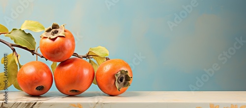 Persimmon fruit from the East with isolated pastel background Copy space photo