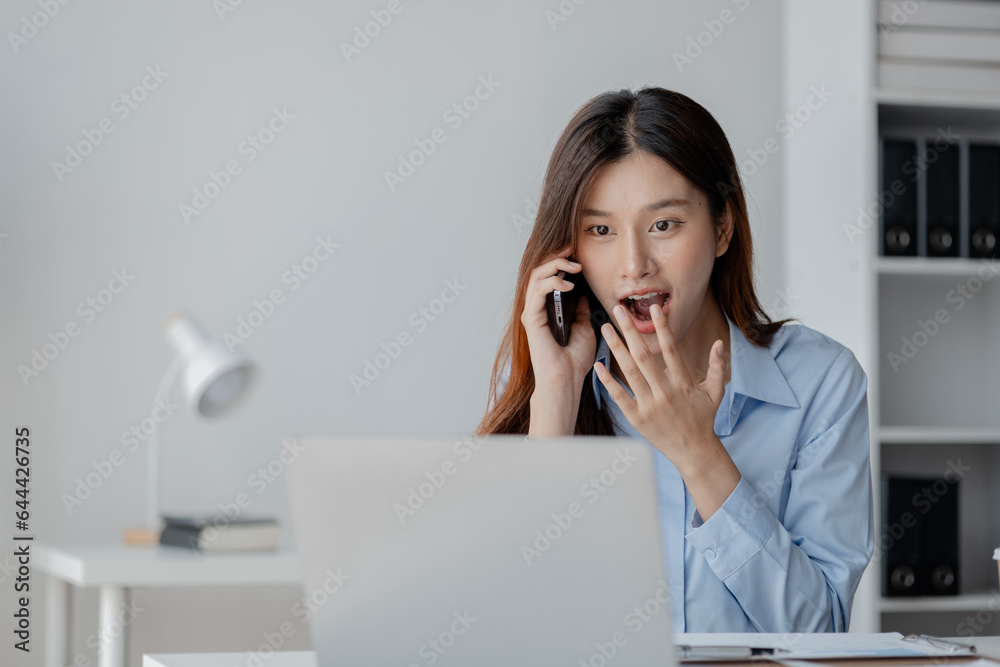 Asian woman talking on the phone, business woman talking on the phone with partner discussing joint venture company, talking on the phone. Communication concept. Asian woman talking on the phone, business woman talking on the phone with partner discussing joint venture company, talking on the phone. Communication concept.