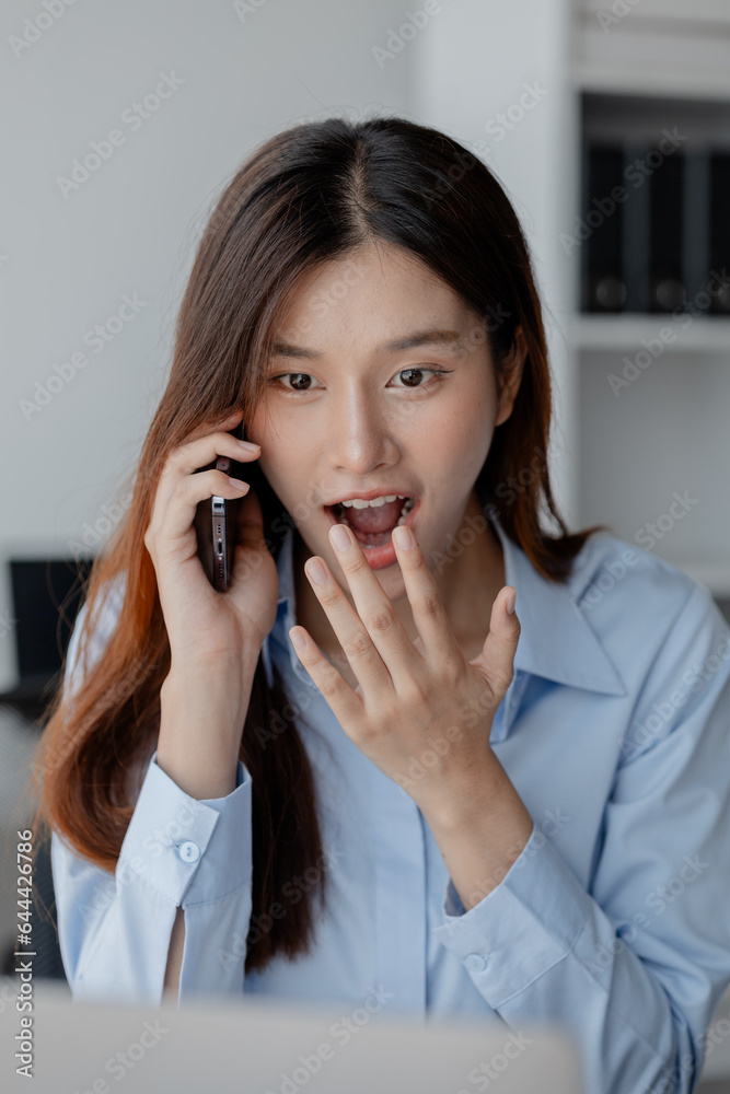 Asian woman talking on the phone, business woman talking on the phone with partner discussing joint venture company, talking on the phone. Communication concept. Asian woman talking on the phone, business woman talking on the phone with partner discussing joint venture company, talking on the phone. Communication concept.