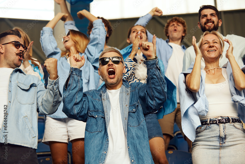 Happiness. Group of sport fans, enthusiasts, people cheering up favourite team during football match. Concept of sport, world cup, team, event and competition, emotions, championship, betting