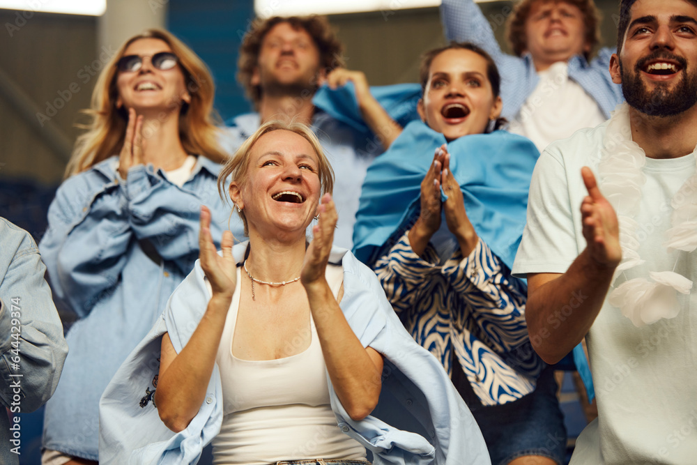 Feeling happy. Men and women, football fans cheering up favourite team in stadium during game. Winning. Concept of sport, world cup, team, event and competition, emotions, championship, betting