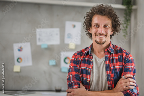 One young man smiling portrait in the office, modern lifestyle and business concept