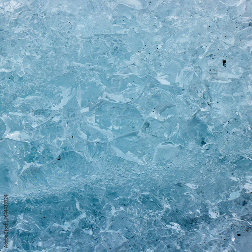 Abstract structure of a blue transparent block of ice. Graphic, monochrome background.