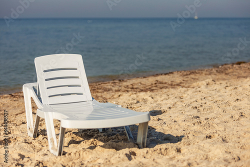 white plastic lounger on the background of the sea © zokov_111