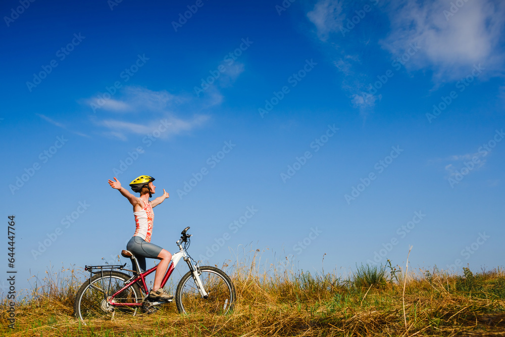 Mountain biking - woman with bike enjoy summer vacation Mountain biking - woman with bike enjoy summer vacation