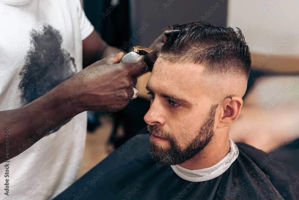 Man getting professional haircut in barbershop Man getting professional haircut in barbershop