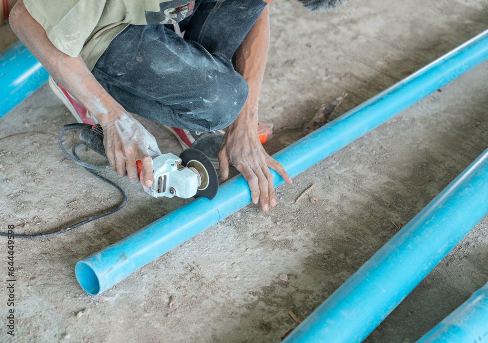 Plumper using electric grinder to cut pvc pipe without gloves. Plumper using electric grinder to cut pvc pipe without gloves.