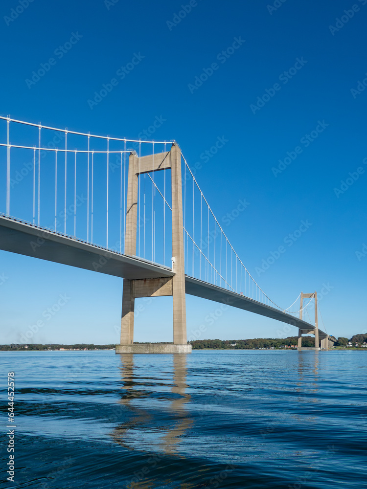 Den nye Lillebæltsbro stretching from Funen to Jutland in Denmark across the Lillebælt strait. Blue sky and sunny summer weather.