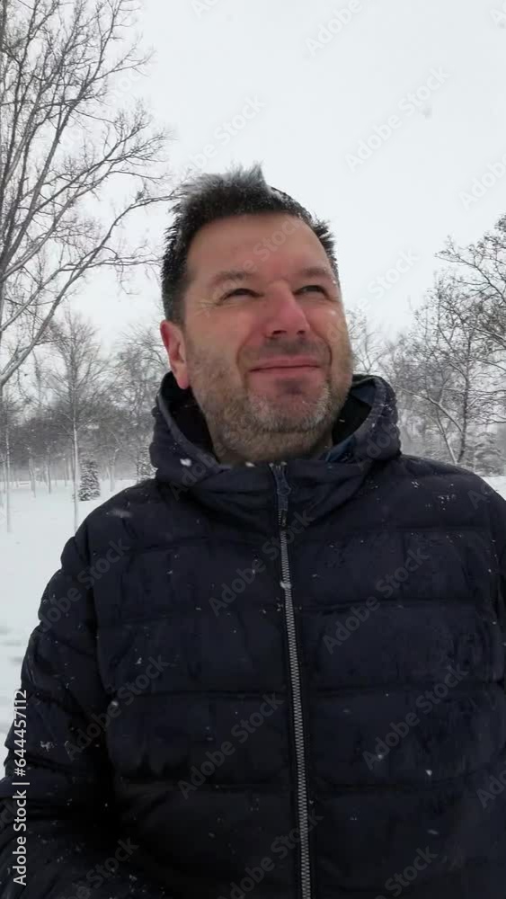 A Man Taking Video Selfies in the Snowy Park. Vertical Video A Man Taking Video Selfies in the Snowy Park. Vertical Video