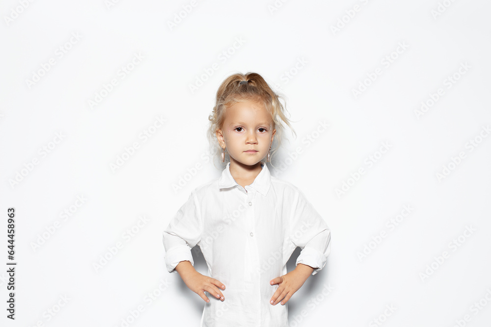 Studio portrait of serious child girl isolated on white background. Studio portrait of serious child girl isolated on white background.