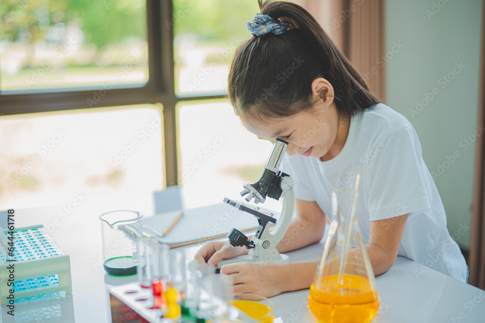 little scientist looking through a microscope and test tubes filled with chemicals for learning about science and experiments. little scientist looking through a microscope and test tubes filled with chemicals for learning about science and experiments.