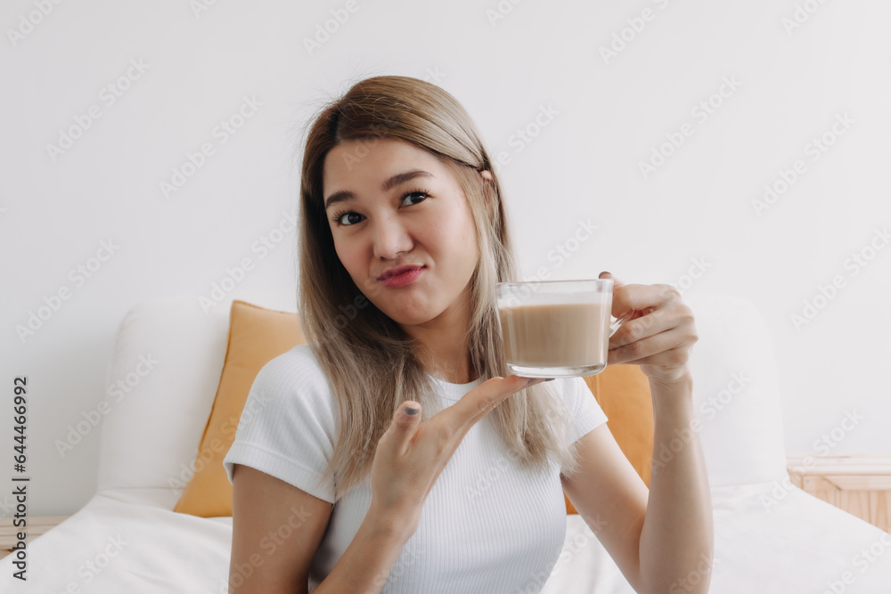 Asian women holding coffee milk cup at apartment. Asian women holding coffee milk cup at apartment.