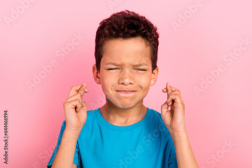 Fotografie Photo portrait of сute little boy crossed fingers hope make wish dressed stylish