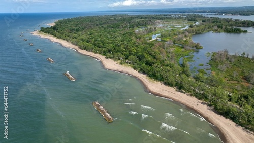 Beautiful sandy beach and coastline of barrier island on Lake Erie Pennsylvania Presque Isle State Park with nature preserve in sunshine on summer day with blue sky and calm waves and surf photo