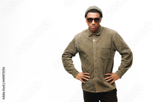 Handsome stylish african-american hipster man looking at the camera with serious face expression isolated on white, guy in sunglasses and hat, fashion man posing in studio © Vadim Pastuh