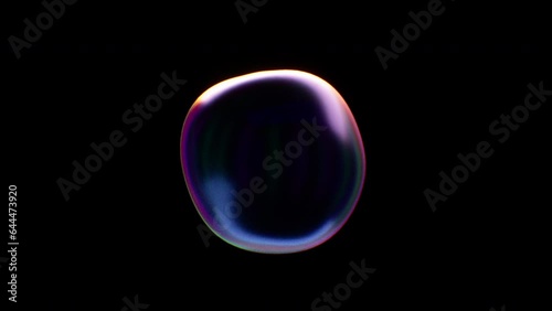 Single Soap bubble isolated flies over a black background for compositing. Seamless loop. Abstract smooth liquid shape