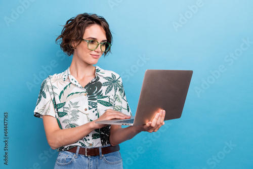Photo of lovely smart nice girl with bob hairstyle dressed colorful blouse look at laptop read email isolated on blue color background