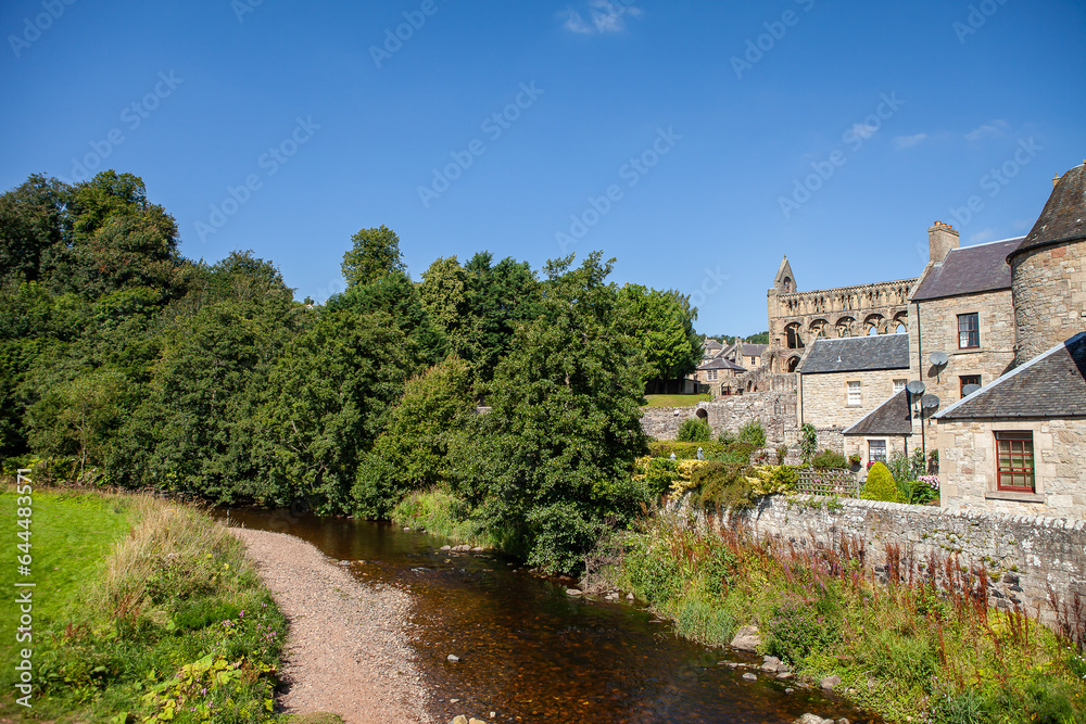 View of Jedburgh former royal burgh in the Scottish Borders. Small city on a river Jed Water with its cathedral. Stunning scottish city with idyllic landscapes and views. Historical landmark. 