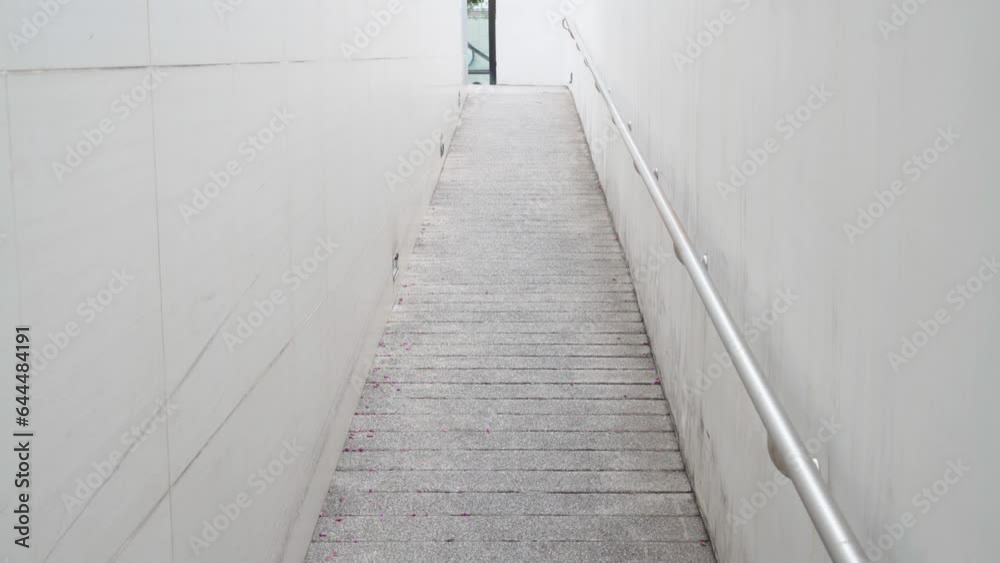 the Wheelchair ramp with the stainless handrail on the wall in the residence. Tilt-up movement with a hand-held. the Wheelchair ramp with the stainless handrail on the wall in the residence. Tilt-up movement with a hand-held.
