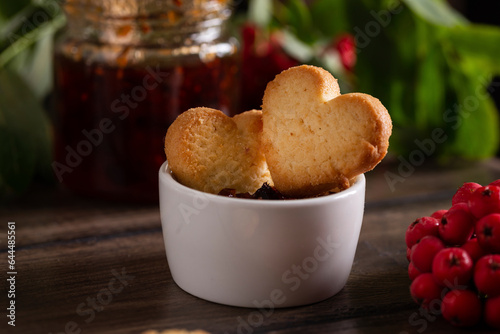 Homemade heart shape cookies in a bowl with jam