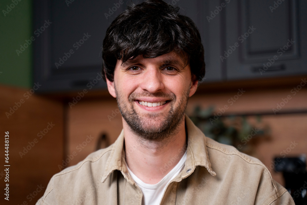 Beautiful smiling young man, Portrait of a happy laid-back guy in the kitchen. Beautiful smiling young man, Portrait of a happy laid-back guy in the kitchen.