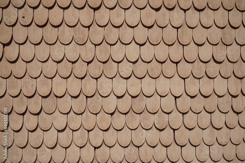 Light wooden tiles of the wall of the house as a pattern 