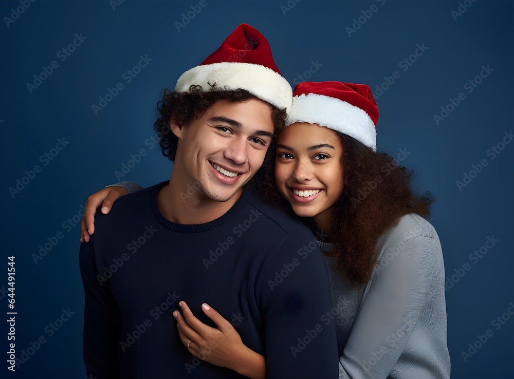 Merry young international couple, Caucasian man and African American woman with Christmas Santa hats hugging, posing isolated on plain pastel light pink, blue background Happy New Year 2023 holiday Merry young international couple, Caucasian man and African American woman with Christmas Santa hats hugging, posing isolated on plain pastel light pink, blue background Happy New Year 2023 holiday