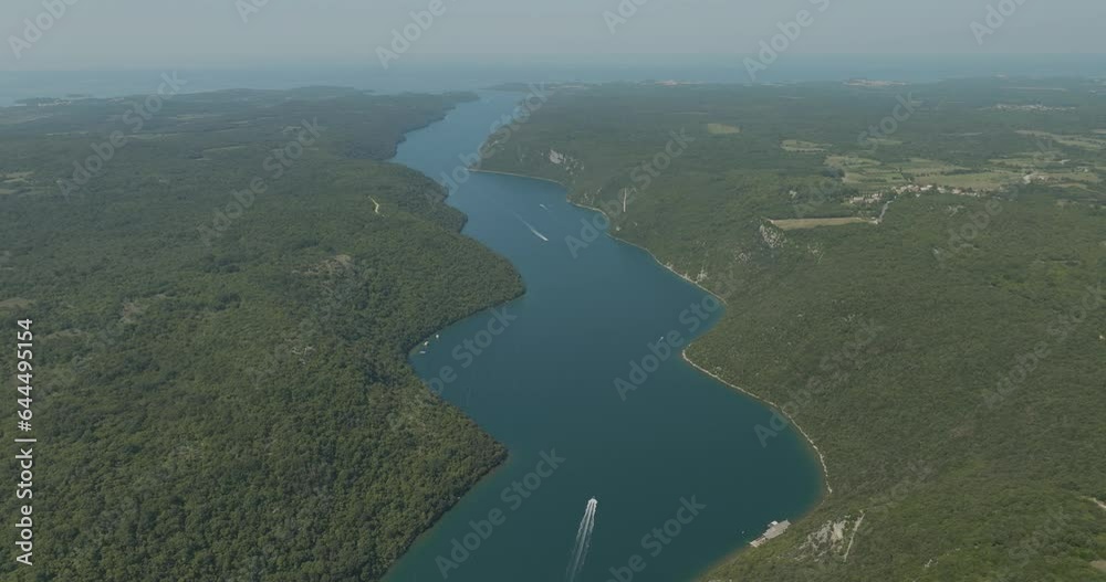 Aerial view of boats sailing along the Limski Fjord (Canal di Leme) in Sveti Lovrec, Istria, Croatia. Aerial view of boats sailing along the Limski Fjord (Canal di Leme) in Sveti Lovrec, Istria, Croatia.
