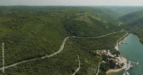 Aerial view of a road on the hills following the Limski Fjord (Canal di Leme) in Sveti Lovrec, Istria, Croatia. photo