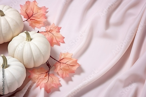 pink pastel pumpkins with fall leaves on soft colored ground with space for text  soft pink fall background