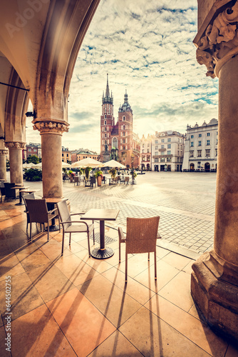 Restaurant table and chairs on old town in Cracow, Poland. View from Cloth hall at sunrise