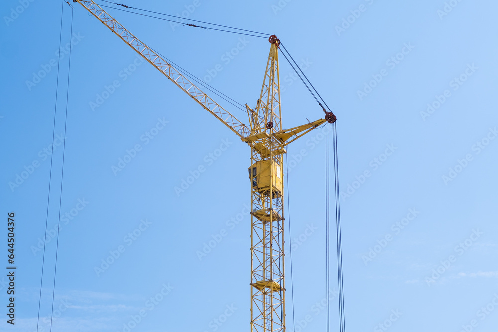 Builders work on large construction sites, and there are many cranes working in the field of new construction.