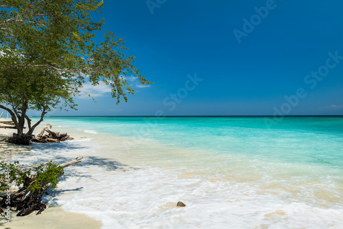 Tropical sandy beach with turquoise ocean water at Gili Trawangan, one of the Gili islands in Lombok, Indonesia
