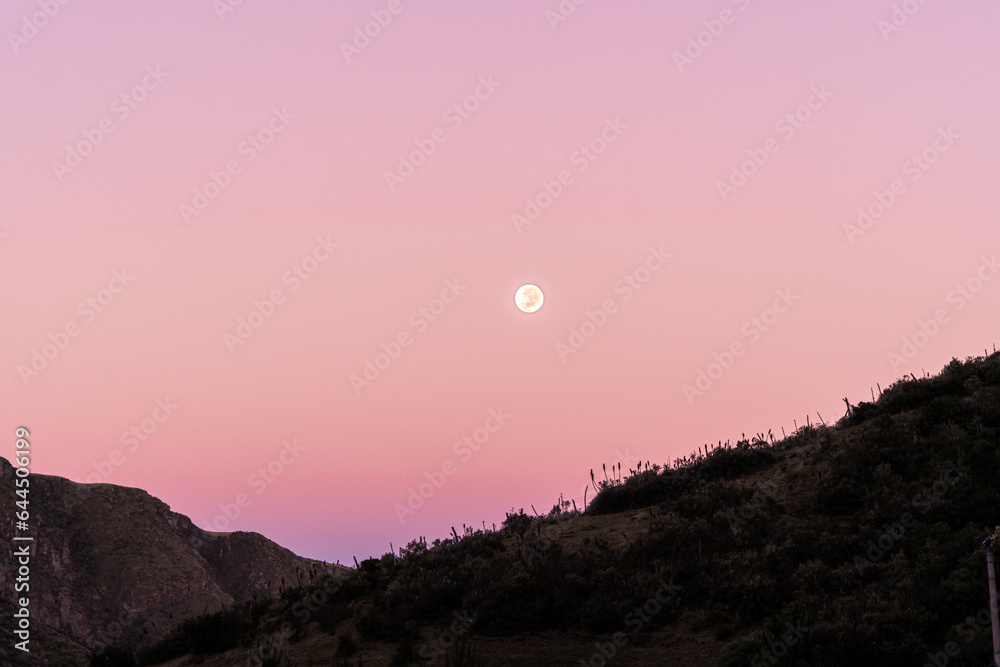 Pink sky with a beautiful supermoon in a sunrise