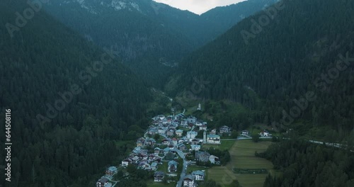 Aerial view of Nebbiu, a small town on the mountain crest on the Dolomites Mountains at sunset, Veneto, Belluno, Italy. photo