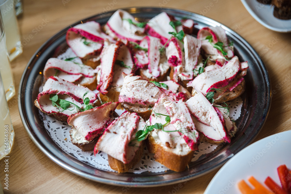 bruschetta with chicken breast meat dyed in beetroot and garnished with pea microgreens on a plate bruschetta with chicken breast meat dyed in beetroot and garnished with pea microgreens on a plate