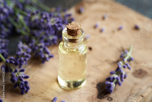Fototapeta Naklejka Na Ścianę i Meble -  A bottle of essential oil with fresh lavender flowers