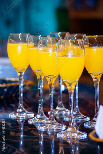 Alcoholic drink made with orange juice and champagne called Mimosa, a space for celebration and joy.